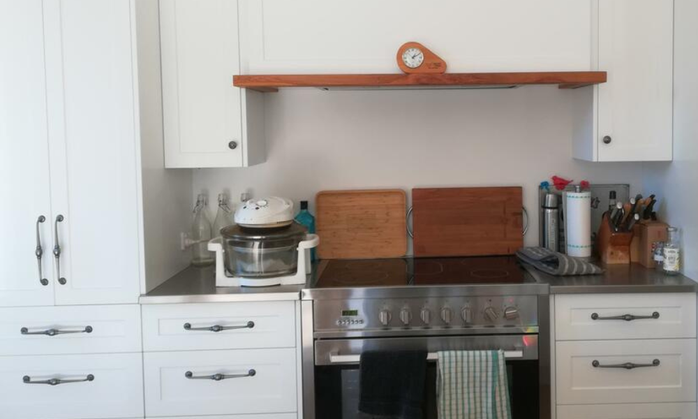 Kitchen with white cabinets, stainless steel appliances, and wooden cutting boards.