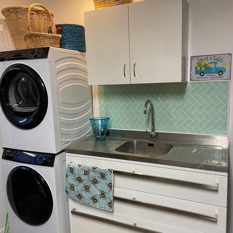 mint green herringbone tiles in laundry
