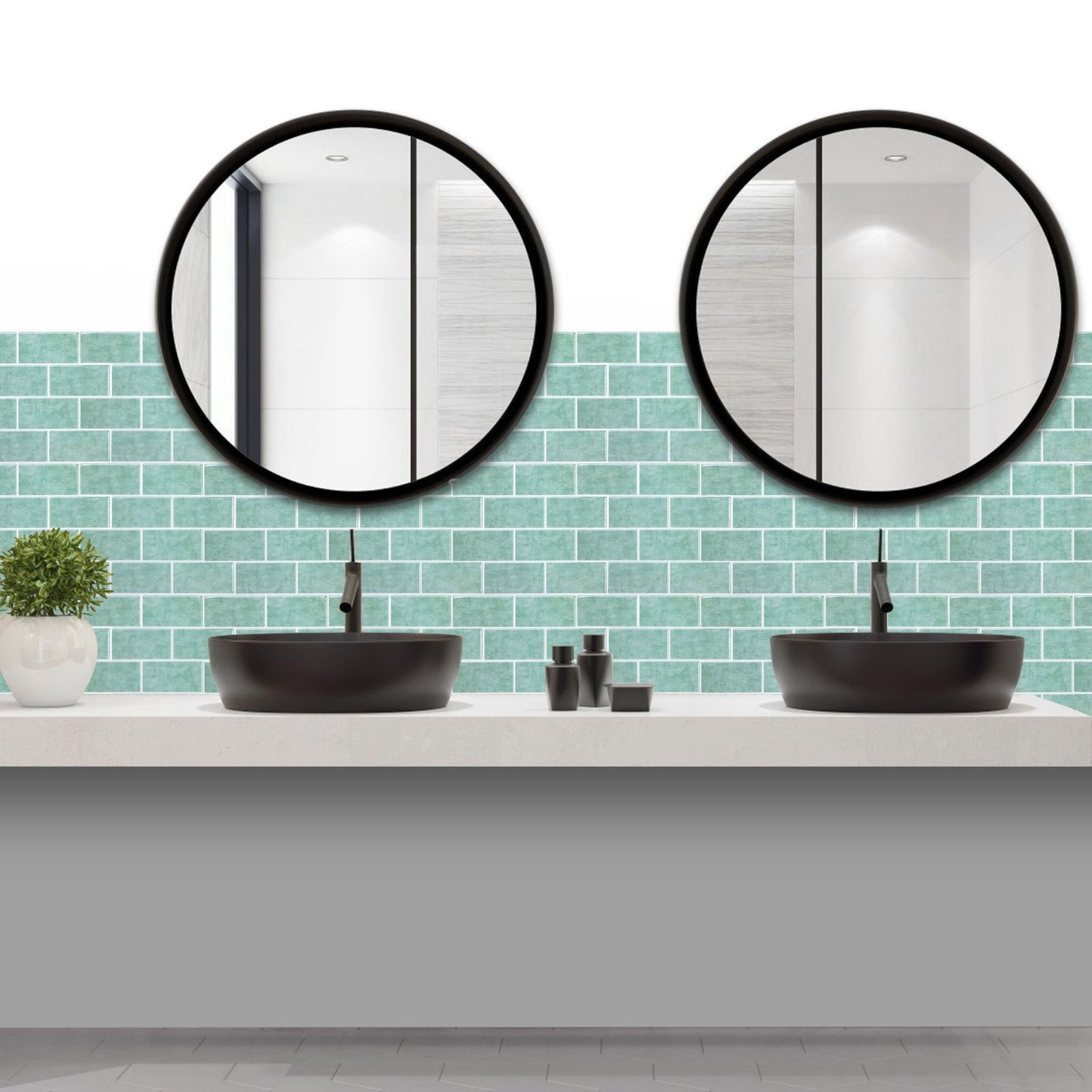 Two round black-framed bathroom mirrors mounted above a double vanity with black vessel sinks and a light teal subway tile backsplash.