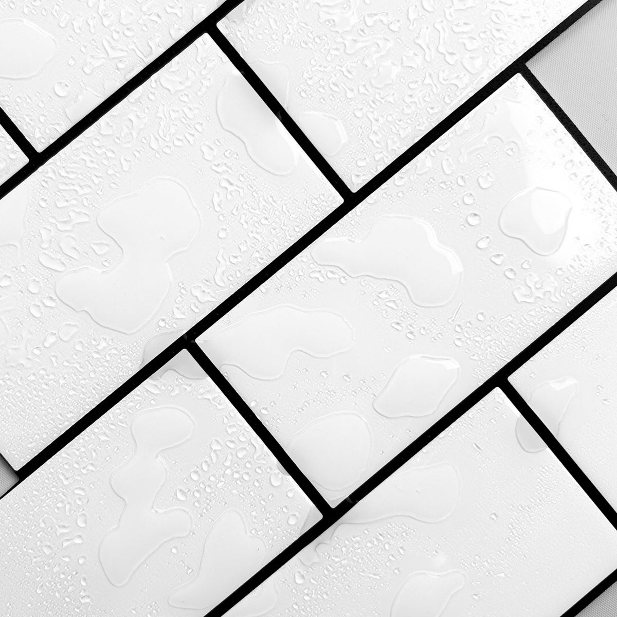 White rectangular subway tiles with black grout lines and water droplets on the surface.