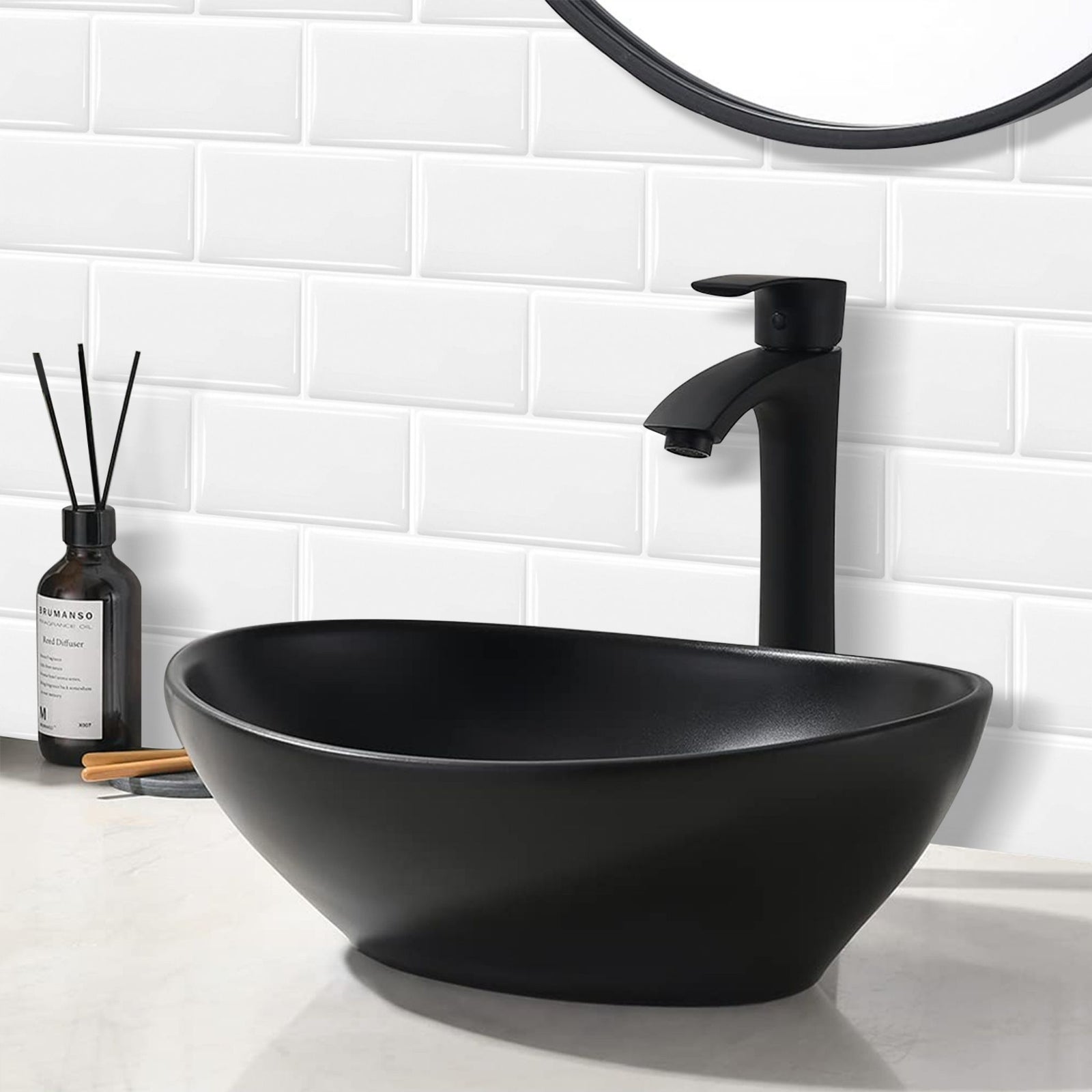 White subway tiles in a bathroom setting with black faucet , sink and mirror